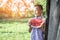 8 years old boy stands in the garden in the village and holds a large piece of watermelon, a small schoolboy smiles on a summer