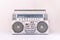 80`s retro cassette radio in silver colour on light wood background