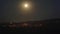 8K Full moon rising in cloudless night sky