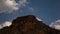 8K Time lapse clouds over the mountain. Blue sky. Orange rocks.