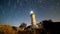 8K. Timelapse of beautiful night landscape with lighthouse with rotating starry sky on a background