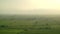 8K Wide Flat Plain Covered With Green Fields at Sunset