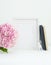 8x10 fram mockup with notebooks, hydrangea, and ring holder