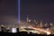 The 9/11 tribute lights seen next to One World Trade, with car light trails from Interstate 278 heading towards NYC