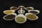 9 Healthy spices in dished with mortar and pestle in center