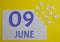 9 june calendar date on a white puzzle with separate details. Puzzle on a yellow background with a blue inscription