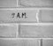 9 A.M. WRITTEN ON WHITE PLAIN BRICK WALL