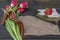 9 May background - George ribbon, note paper, red flowers front-line letters, military cap and orders on the wooden background.