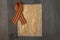 9 May background - George ribbon and note paper on the wooden background. Victory day or fatherland defender day concept. Top view