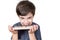 9 year old boy showing his teeth and holding a tray with several Brazilian fudge balls