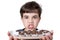 9 year old child holding a tray with several Brazilian fudge balls and grinding his teeth
