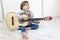 9 year old girl learning to play the guitar.