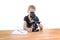 A 9-year-old girl looks into an eyepiece of a microscope and sharpens the picture. She can write down her observations on a note