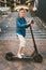 90 year old woman with gray hair, wrinkles, progressive and active uses modern electric transport scooter. Lady