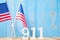 911 text and United States of America flag on wooden table background. Patriot Day, September, memorial and Never Forget concept