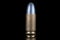 9mm caliber round isolated on black with reflexion