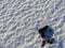 A 9mm pistol and bullets scattered in the snow.