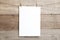 A4 mock up - empty sheet of paper on a wooden background - blank A4 sheet on clothespins