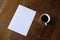 A4 mockup top view with cup of coffee on wooden table vertical horizontal