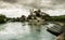 Aarburg village with the caste and church and the river Aare with boats in the foreground