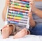 Abacus, math and baby with mother playing, learning and teaching for child development on bed. Bonding, toy and closeup