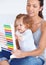 Abacus, math and girl baby with mom playing, learning and teaching for child development on bed. Bonding, toy and young