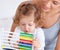 Abacus, math and toddler with mother playing, learning and teaching for child development on bed. Bonding, toy and
