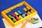 Abacus for teaching children to count. Abacus device for performing arithmetic calculations, notebook for records, colored pencil
