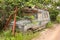 Abandon old rusted van left on the side of a dirt road