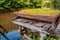 Abandoned aged grand piano covered in the grass near the Vilnia River, Vilnius, Lithuania