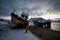 Abandoned, already rotten skeletons of ships lying on the coast of the Arctic ocean against the background