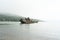 Abandoned antique old wooden ship at sea tropical landscape surrounded by fog