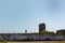 The abandoned area of an old granary with tall stone cylindrical silos