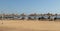 Abandoned beach with sunbeds, umbrellas and a volleyball net overlooking the sea