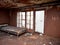 abandoned bedroom with broken windows