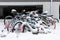 Abandoned bicycles covered with snow near apartment building parking lot in winter season