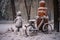 abandoned bike with a snowman built next to it in a winter park