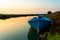Abandoned blue fishing boat at dawn in ebro delta park in catalunya, a quiet scene with warm colors symbol of loneliness and peace
