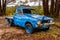 Abandoned blue vintage utility truck decaying with time