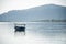 abandoned boat adrift marooned in the middle of water of lake pichola surrounded by aravalli hills in tourist city of