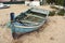 Abandoned boat on the beach. Old blue fishing on the sand. Atlantic. Portugal. Travel background Europe.