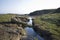 Abandoned boat by stream in peat