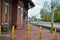 Abandoned brick train depot with tracks and graffiti