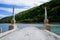 Abandoned bridge going underwater near water dam