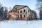 Abandoned and broken old two-storey brick house in the forest