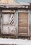 Abandoned building with old retro doors. Clouse-up of a very old weathered wooden door.