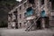 Abandoned building in ruined by mudflow old town high in mountains with intricate stonework, ruined balconies, crashed