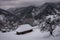 Abandoned cabin after snowstorm in winter mountains