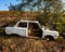 Abandoned car body in dry grass