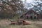 Abandoned car in front of a rustic farm house. Ai generated